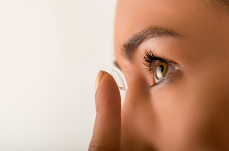 Close up of a woman putting in a contact lens