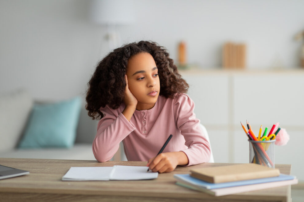 Bored looking girl at a desk