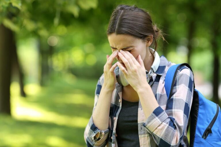 Woman rubbing her irritated eyes